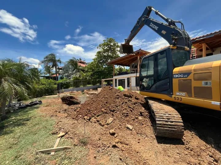 Excavator working beside a villa in Guanacaste, from the Guanacaste Earthmoving page